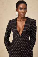 A black mini dress with embellished stripes and a short hemline featuring the name Mireille