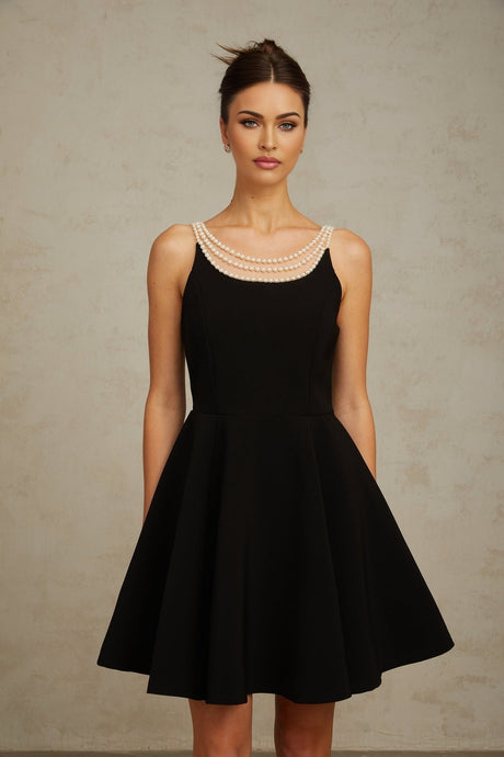 A black mini dress with faux pearl embellishments named Danae