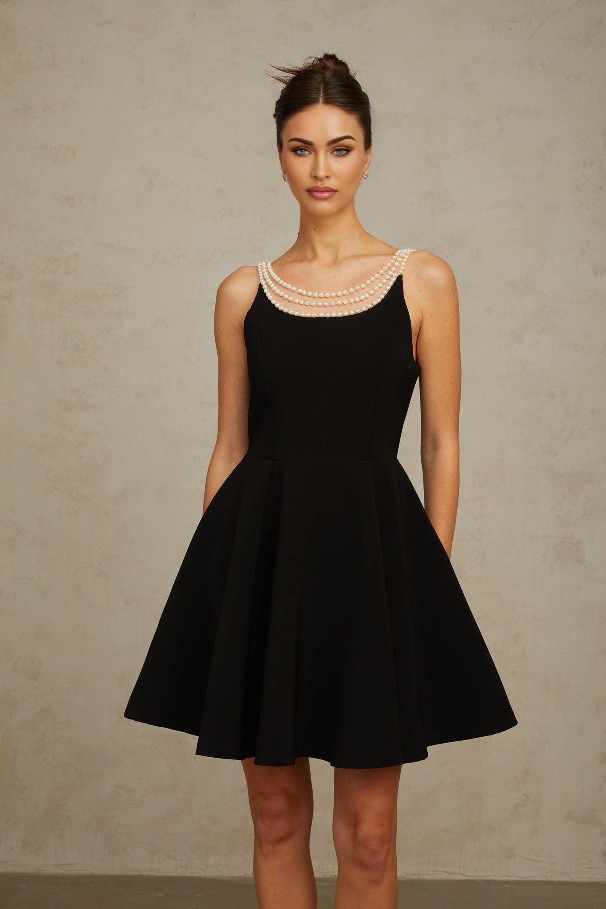 A black mini dress with faux pearl embellishments named Danae