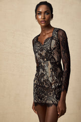A black mini dress with floral embroidery and lace detailing featuring a short hemline and delicate floral patterns woven into the fabric