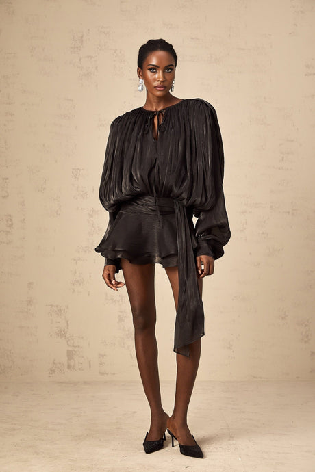 A black mini dress with full pleats and ruffled details named Eugenie