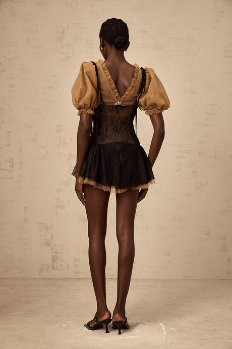 A black mini dress with lace panelling details and a fitted silhouette