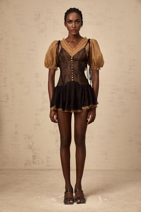 A black mini dress with lace panels featuring a fitted silhouette and delicate lace detailing throughout the bodice and sleeves