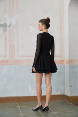 A black mini dress with puff sleeves and pointelle detailing named Helene