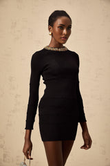 A black mini dress with ribbed knit fabric and allover sequin embellishment featuring a formfitting silhouette and short length