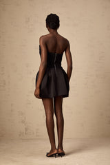 A black mini dress with ruched detailing and puff sleeves called the Francis dress