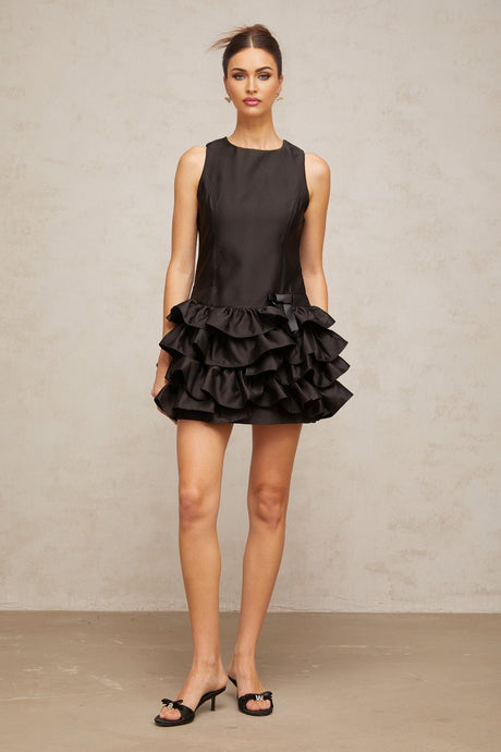 A black mini dress with ruffled tiers and a short hemline named Therese
