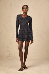 A black mini dress with sequin embellishments and a knitted texture featuring a short hemline and fitted silhouette