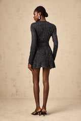 A black mini dress with sequin embellishments and a knitted texture featuring a short hemline and formfitting silhouette