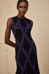 A black mini dress with snake pattern design featuring godet inserts and a flared silhouette named Anais