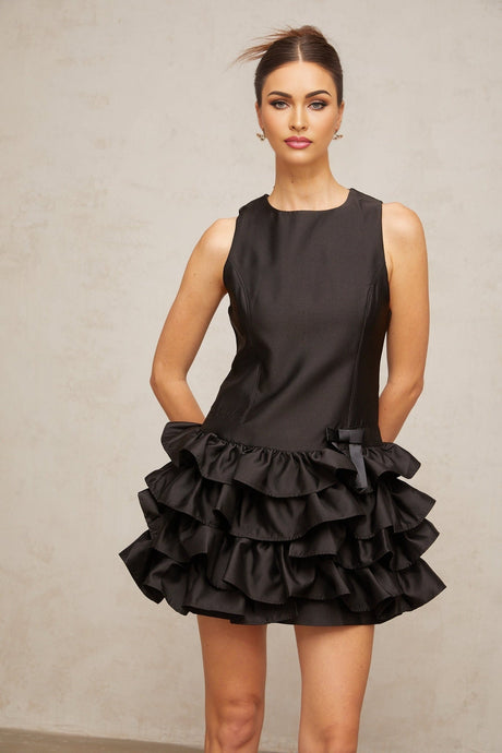 A black mini dress with tiered ruffles and a short hemline named Therese