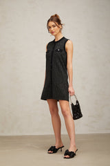 A black mini dress with vertical stripes and sequin embellishments featuring a knit fabric and a short hemline inspired by Zelda style
