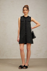 A black mini dress with vertical stripes made of sequins and knit fabric featuring a Zelda design