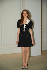 A black mini dress with waffle knit texture and embellishments named Ava featuring a short length and decorative details