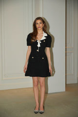 A black mini dress with waffle knit texture and embellishments named Ava featuring a short length and decorative details