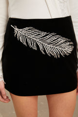 A black mini skirt with embellished feather embroidery details named Myriam