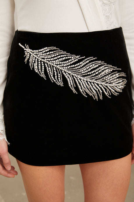 A black mini skirt with embellished feather embroidery details named Myriam