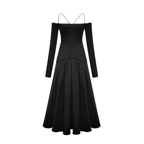 A black offshoulder maxi dress with panelled design worn by a model standing against a plain background