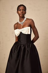 A black offshoulder midi dress made of georgette fabric featuring a bowknot detail