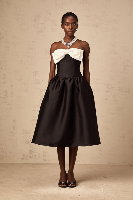 A black offshoulder midi dress made of georgette fabric featuring a bowknot detail
