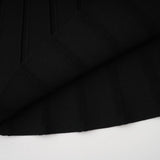 A black offshoulder mini dress with a bow detail and knit fabric featuring a fitted silhouette and short length