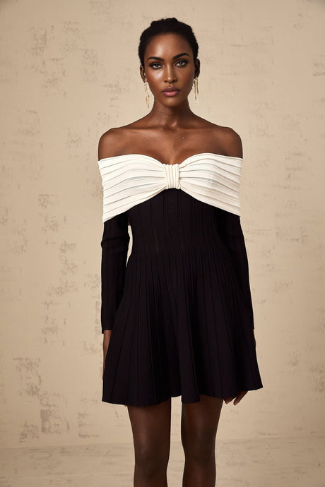 A black offshoulder mini dress with a bow detail and knit fabric featuring a fitted silhouette and short length