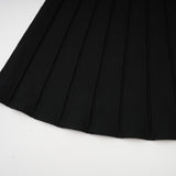 A black offshoulder mini dress with a bow detail and knit fabric worn by a model