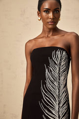 A black offshoulder mini dress with feather motif embellishments named Jelena