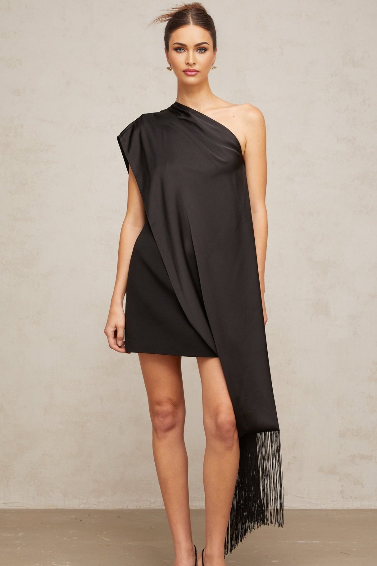 A black oneshoulder mini dress suitable for Valentines Day featuring a sleek and elegant design with a fitted silhouette and asymmetrical neckline