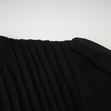 A black pleated midi dress with a button front design and short sleeves named Viviane