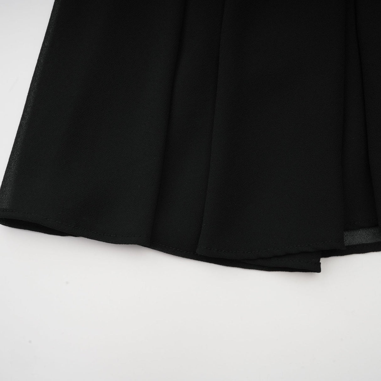 A black pleated midi dress with a buttonfront design named Viviane