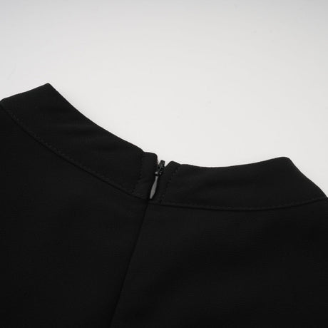 A black pleated midi dress with button front closure and a sleek silhouette named Viviane