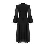 A black pleated midi dress with button front closure and sleeveless design featuring a fitted waist and flared skirt