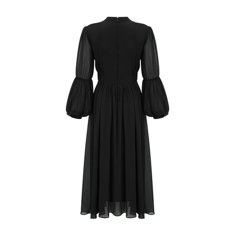 A black pleated midi dress with buttonfront closure featuring a feminine silhouette and Viviane design