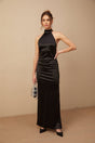 A black satin maxi dress with a halterneck style adorned with faux pearls the dress has a long flowing silhouette and is named Ginevra