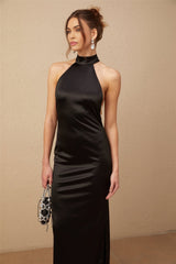 A black satin maxi dress with a halterneck style featuring faux pearl embellishments