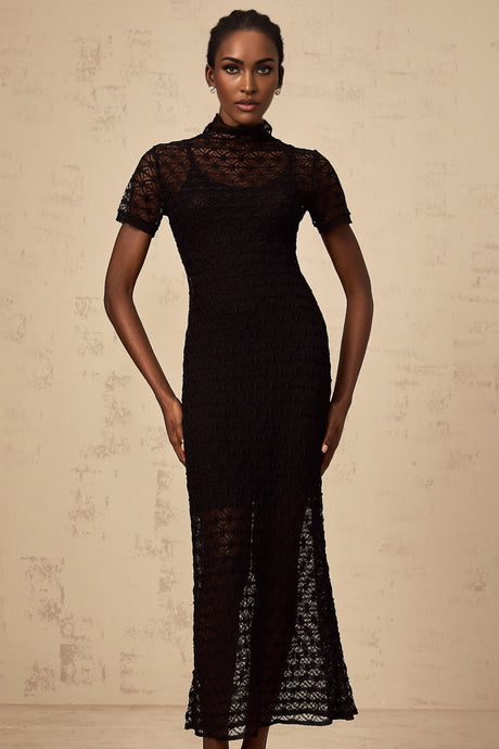 A black semi sheer knit midi dress on a mannequin or model showing the fitted silhouette and texture of the fabric