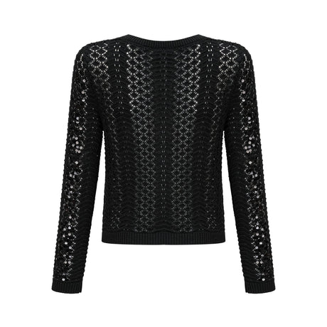 A black sequined cardigan and matching skirt set featuring crochet knit design The cardigan has long sleeves and an open front while the skirt is form fitting Both pieces are adorned with shimmering sequins throughout creating an elegant evening look