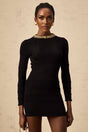 A black short dress with a ribbed knit texture covered in shiny sequins featuring a closefitting design and mini length
