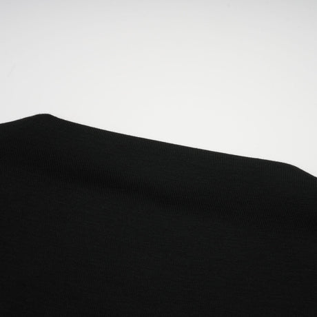 A black sleeveless top with an open front design and gathered fabric details