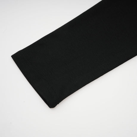 A black sleeveless top with an open front design and gathered fabric details