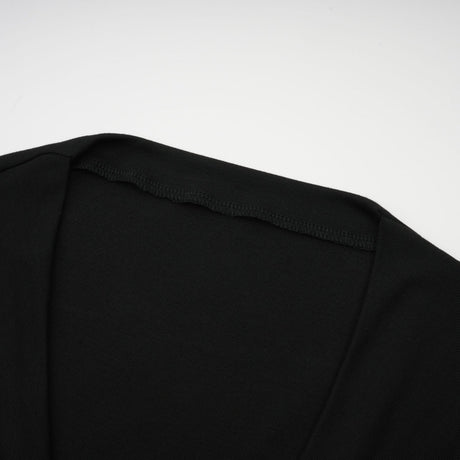 A black sleeveless top with an open front design featuring gathered fabric details