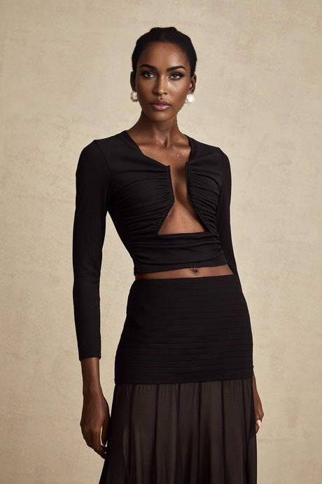 A black sleeveless top with an open front design featuring gathered fabric details