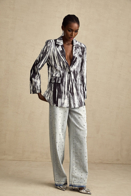 A black textured jacket with graffiti print design covering the surface