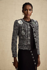 A black tweed jacket with a checked pattern and frayed edges named Justine