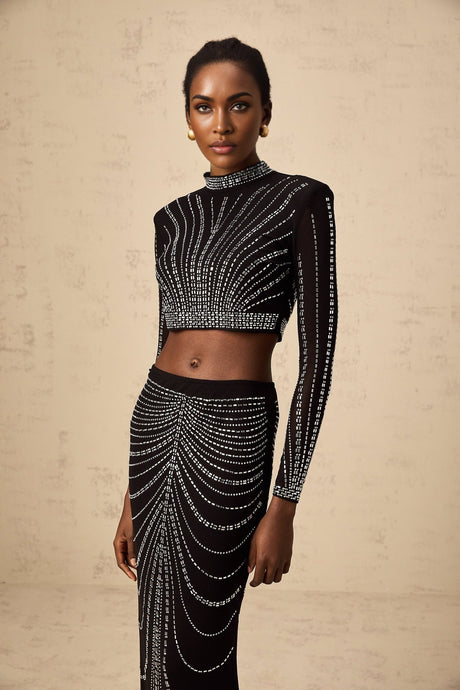 A black twopiece outfit consisting of a mesh top and skirt adorned with rhinestones The set features a sleeveless top and a fitted skirt both embellished with sparkling details for a glamorous look