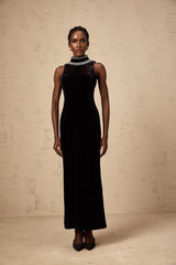 A black velvet gown adorned with crystal embellishments featuring a long silhouette and elegant design
