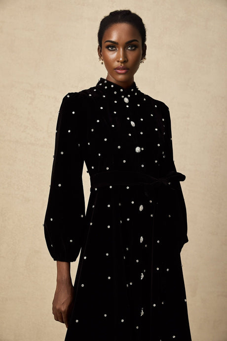 A black velvet midi dress with embellishments named Lola featuring a sleek design and elegant detailing