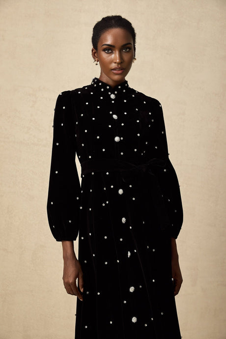 A black velvet midi dress with embellishments named Lola featuring a sleek silhouette and decorative details
