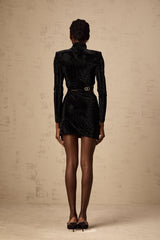 A black velvet mini dress with cut out details and stud embellishments by Yvette